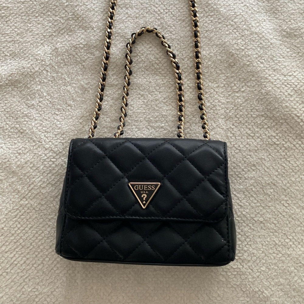 Guess clutch with adjustable straps. Very soft.  Used only once for a wedding.